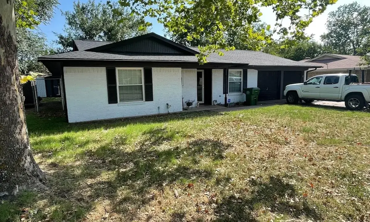 Professional roofing crew working on a residential roof in Ferguson